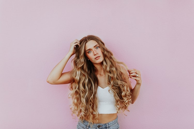 woman with long curly hair posing